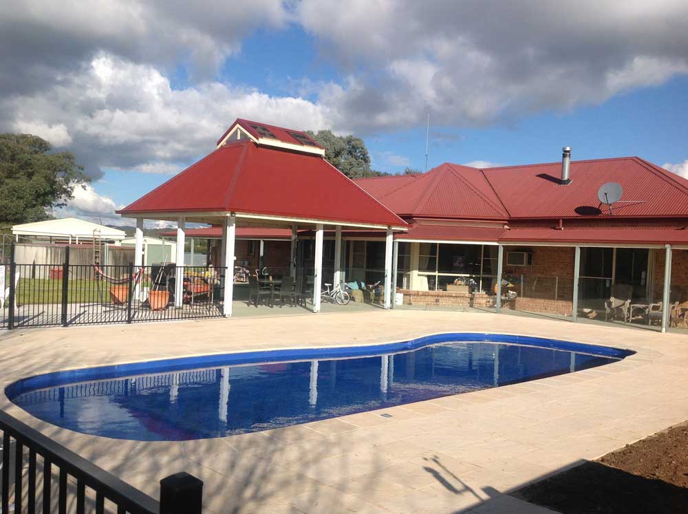 Finished pool with fencing and paving