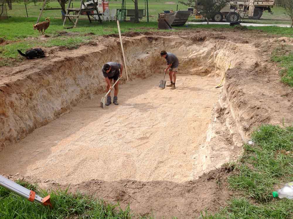 Excavate hole and level crusher dust base