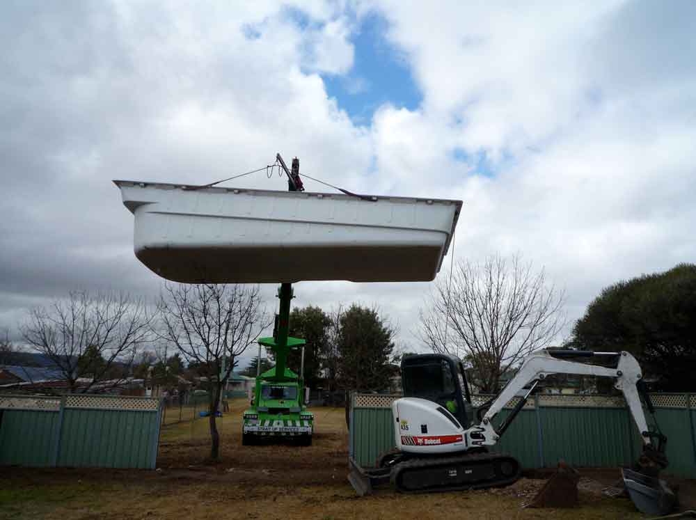 Pool is lifted into hole and levelled and then back filled